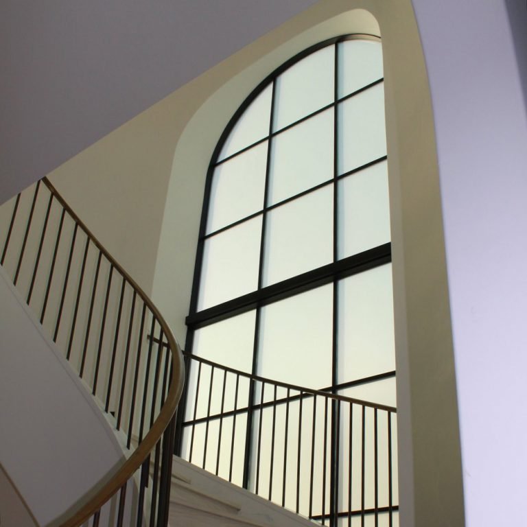 large window with frosted window film next to stairs